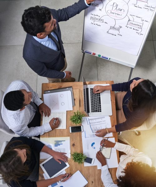 High angle shot of a group of businesspeople having a meeting around a table.